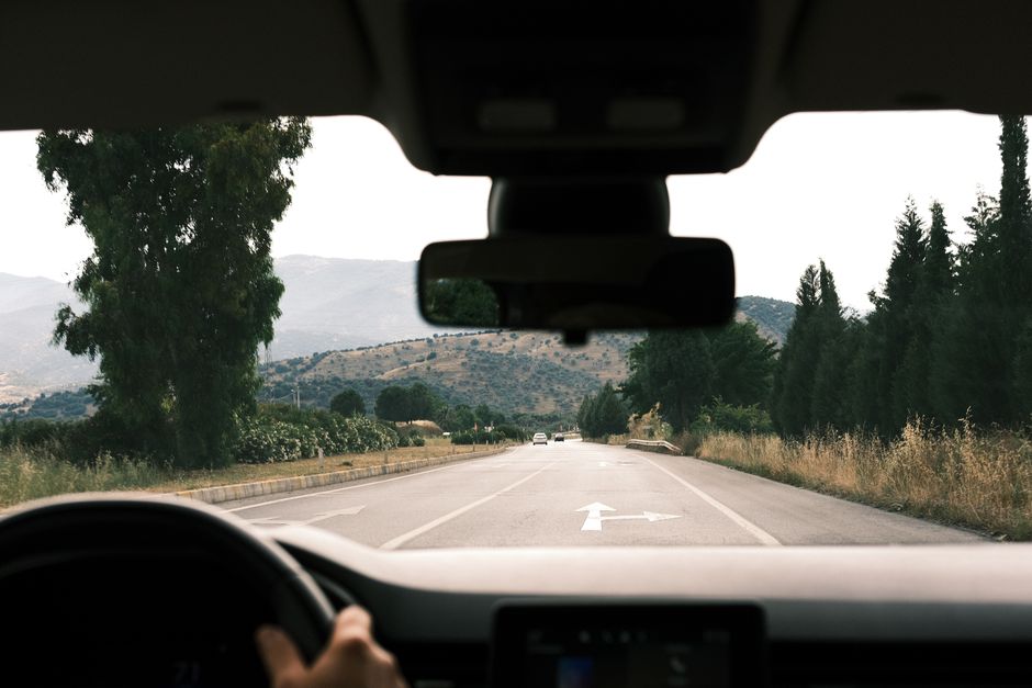 Clear windshield view from inside a car driving on a sunny day